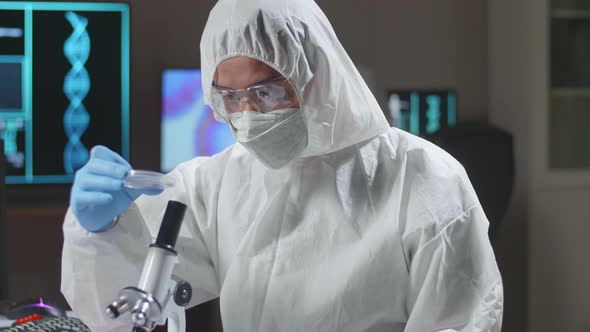 Doctor In Protective Suit Is Doing A Science Experiments And Developing Vaccine In A Modern Lab