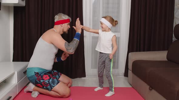 Sportsman Man Coach Working Out with Child Kid Girl Boxing Exercises with Daughter at Home on Mat