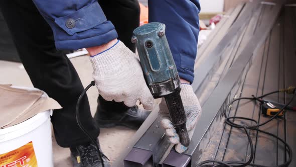 Rivet pistol in action, worker installing rivets