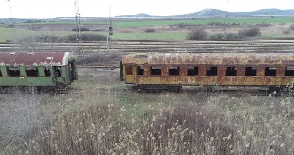 Aerial view of abandoned old railway wagons at station. Old train wagons