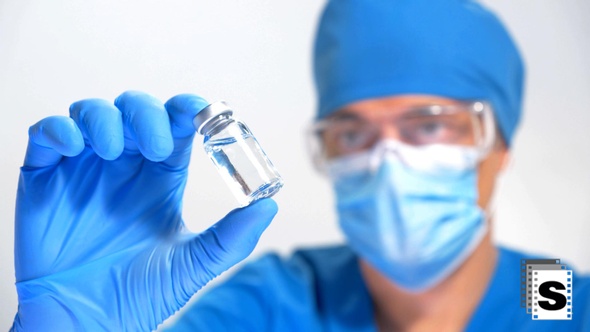 Scientist Looking Vaccine Bottle