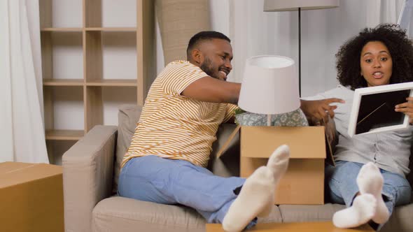 Happy Couple with Boxes Moving To New Home