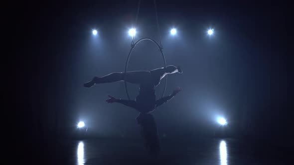 Aerial Acrobat in the Ring. A Young Girl Performs the Acrobatic Elements in the Air Ring in the