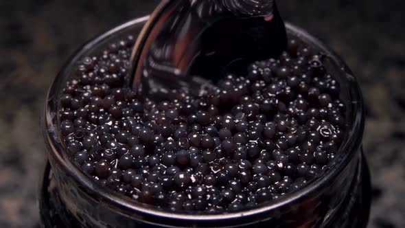 Super Close-up of Black Caviar Taken From the Glass Bowl 