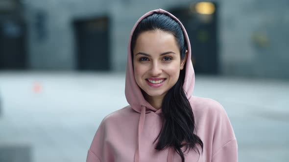 Closeup Beautiful Woman Looking Camera Outdoor. Fitness Woman Posing To Camera