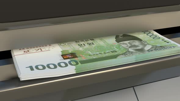 10000 South Korean won in cash dispenser. Withdrawal of cash from an ATM.