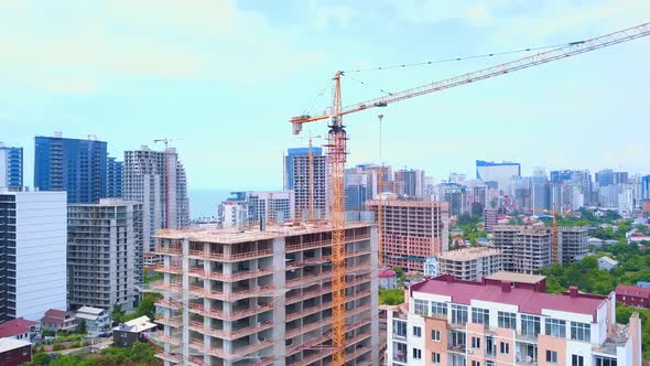 Drone view of a multi-storey building under construction with a tower crane