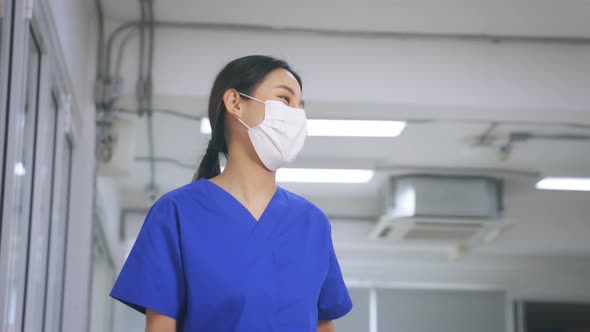 Medical Workers in Mask Elbow Bumps While Maintaining Social Distancing During Corona Virus Outbreak