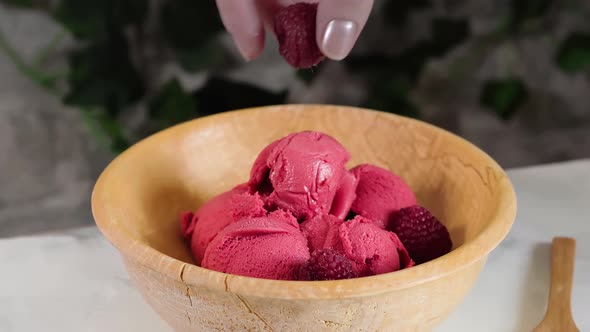 Delicious Raspberry Sorbet in Wooden Bowl