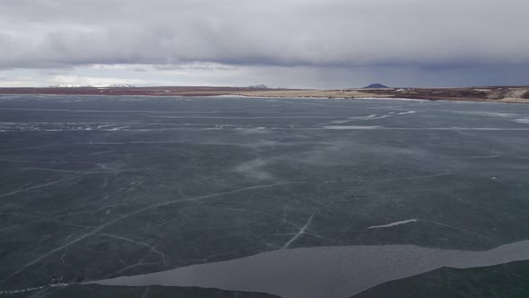 Flight over a frozen lake in Iceland wilderness landscape