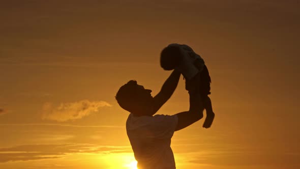 Loving Father Playing with Son at Sunset alt