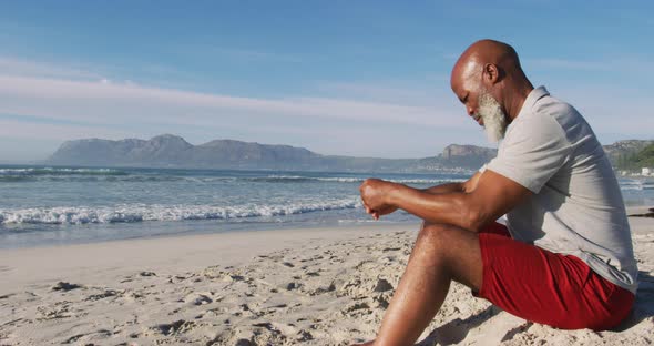 Senior african american man sitting at the beach