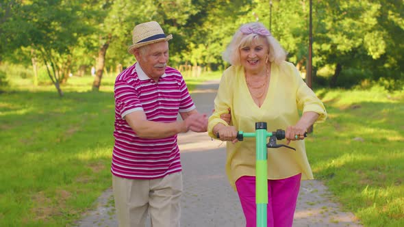 Senior Old Stylish Tourists Grandmother Grandfather Using Electric Scooter Enjoying Learning Ride