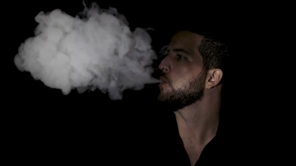 Slow motion close up smoking man on black background