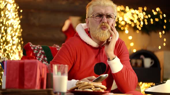 Excited Santa Claus at Home Watch Tv Holding Remote Control Near Christmas Tree.