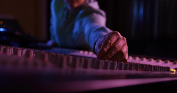 Male sound engineer working at a mixing desk