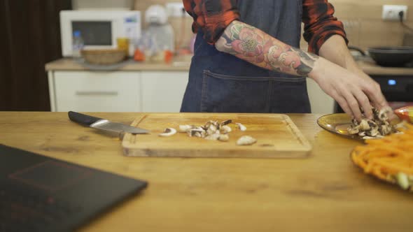 Close Shot of Chef Hands Chopping Mushrooms on a Wooden Chopping Board