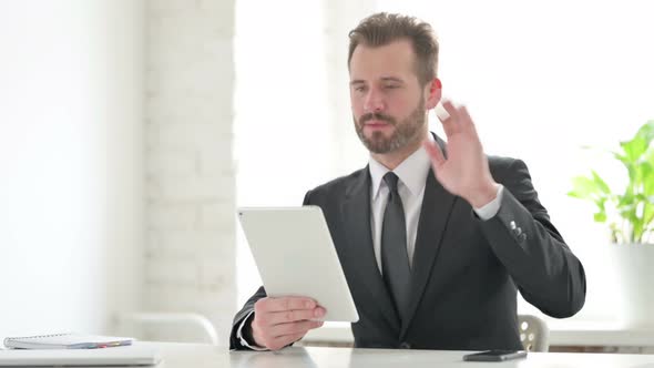 Young Businessman Making Video Call on Tablet in Office