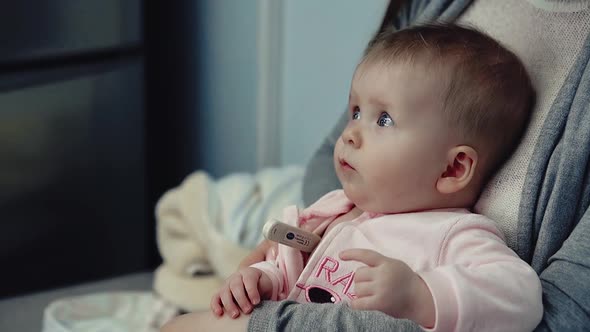 Child Holding a Thermometer in Arm