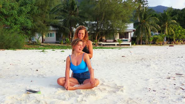 Beautiful fun women on holiday enjoying life at the beach on summer white sandy and blue 