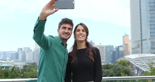 Tourist visit Hong Kong and taking selfie on mobile phone