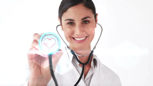 Smiling doctor holding stethoscope that shows heartbeat