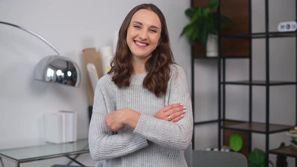 Modern Woman Entrepreneur Stands with Arms Crossed