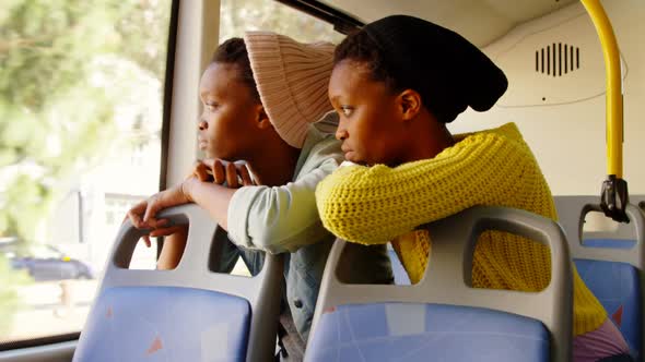 Twin sisters looking through window in the bus 4k