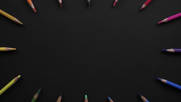 Wooden School Pencils of Different Colors Are Located on the Black Surface. Stop Motion Animation