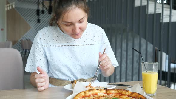 Lady Eats Pizza Enjoying in the Restaurant