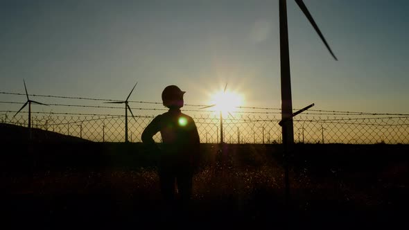 Woman engineer inspecting a wind farm in California