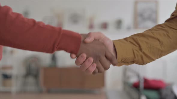 Hands Close up of African Man and Young Man Shaking Hands