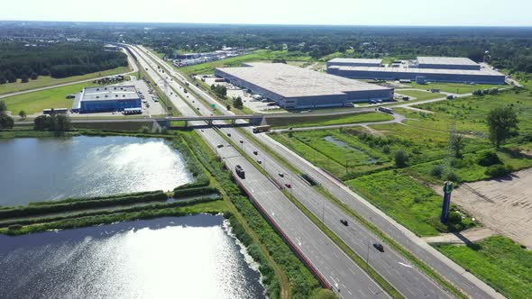 Aerial top view of the large logistics park with warehouse, loading hub with many semi-trailers truc