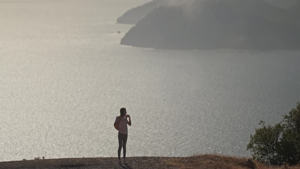 Silhouette of Young Woman Tourist Enjoying Beautiful Seascape of Aegean Coastline Mediterranean Sea