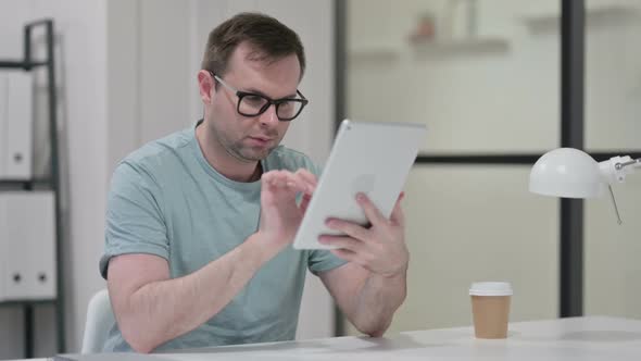 Young Man Using Tablet at Work