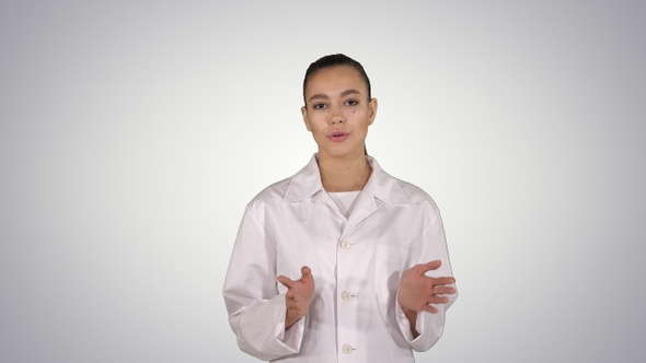 Woman doctor explaining and talking to camera while walking