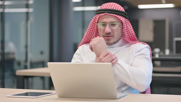 Middle Aged Arab Man with Laptop having Wrist Pain