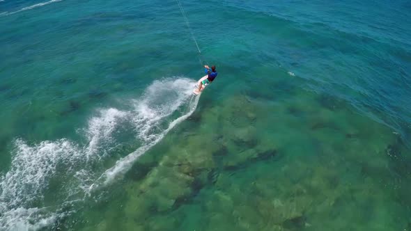 Aerial view of a man kitesurfing in Hawaii