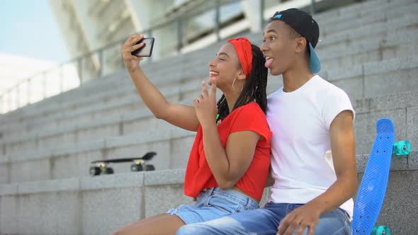 Multi-Ethnic Teenagers Making Selfie and Having Fun Sitting on Stairs Outdoor