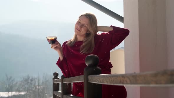 Young woman on balcony at chalet.