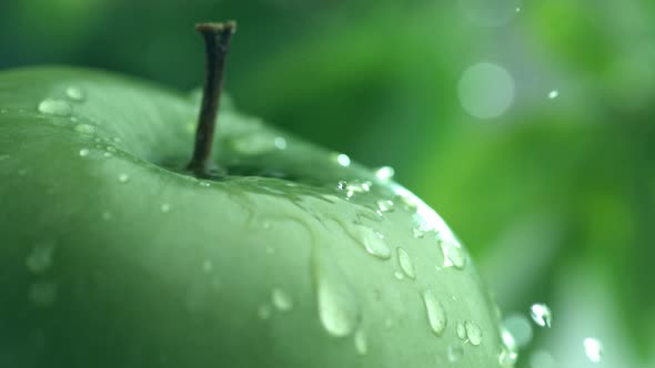 Extreme close-up of water drip on apple in slow motion; shot on Phantom Flex 4K at 1000 fps alt