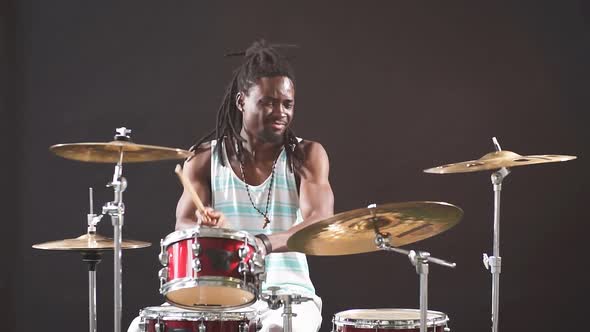 Professional African Drummer Man Playing on Drums and Cymbals