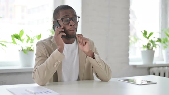 African Man Talking on Smartphone in Office