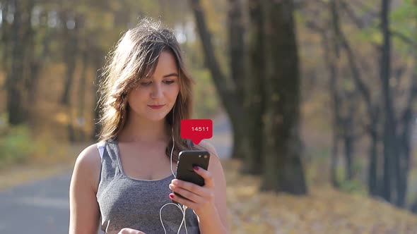 Young girl with phone feels happy in the sun in the park