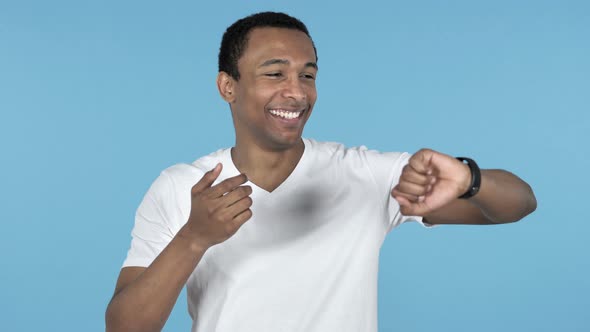 Online Video Chat By Young African Man on Smartwatch, Blue Background