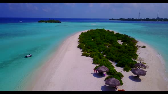 Aerial above nature of marine island beach holiday by blue green ocean with white sandy background o