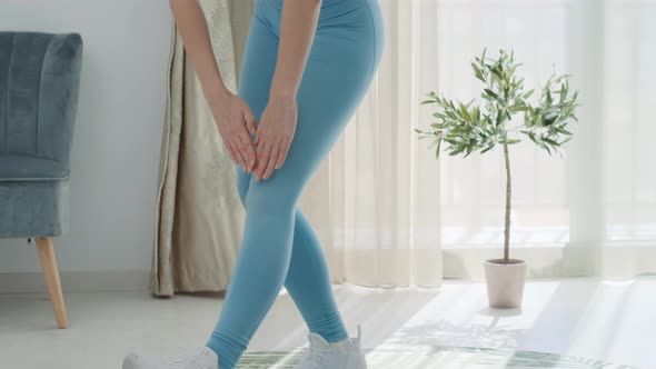 Close up female legs healthy woman in blue sportswear doing exercises at home