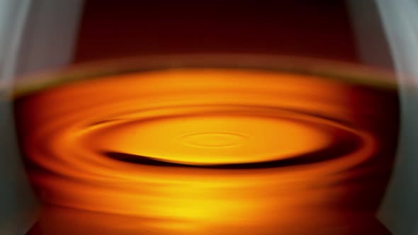 Super Slow Motion Detail Shot of Swirling Whiskey in Glass at 1000Fps