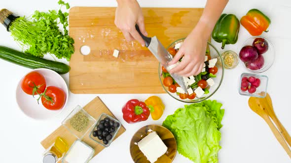 Woman Cooking Vegetable Salad with Feta and Spices