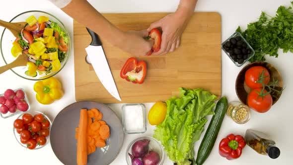 Woman Cutting Pepper in Half and Removing Seeds